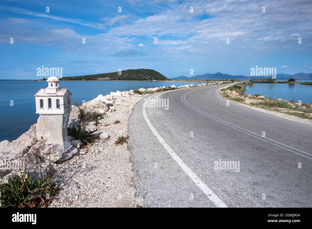A roadside shrine on the causway across the Ambracian Gulf between Salaora and Koronisia island,  Arta Municipality, Epirus, Greece. Stock Photo