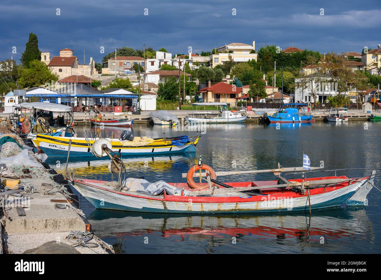 Traditional fishing boats in the harbour at the village of Koronisia on Koronisia island in the Ambracian Gulf,  Arta Municipality, Epirus, Greece. Stock Photo
