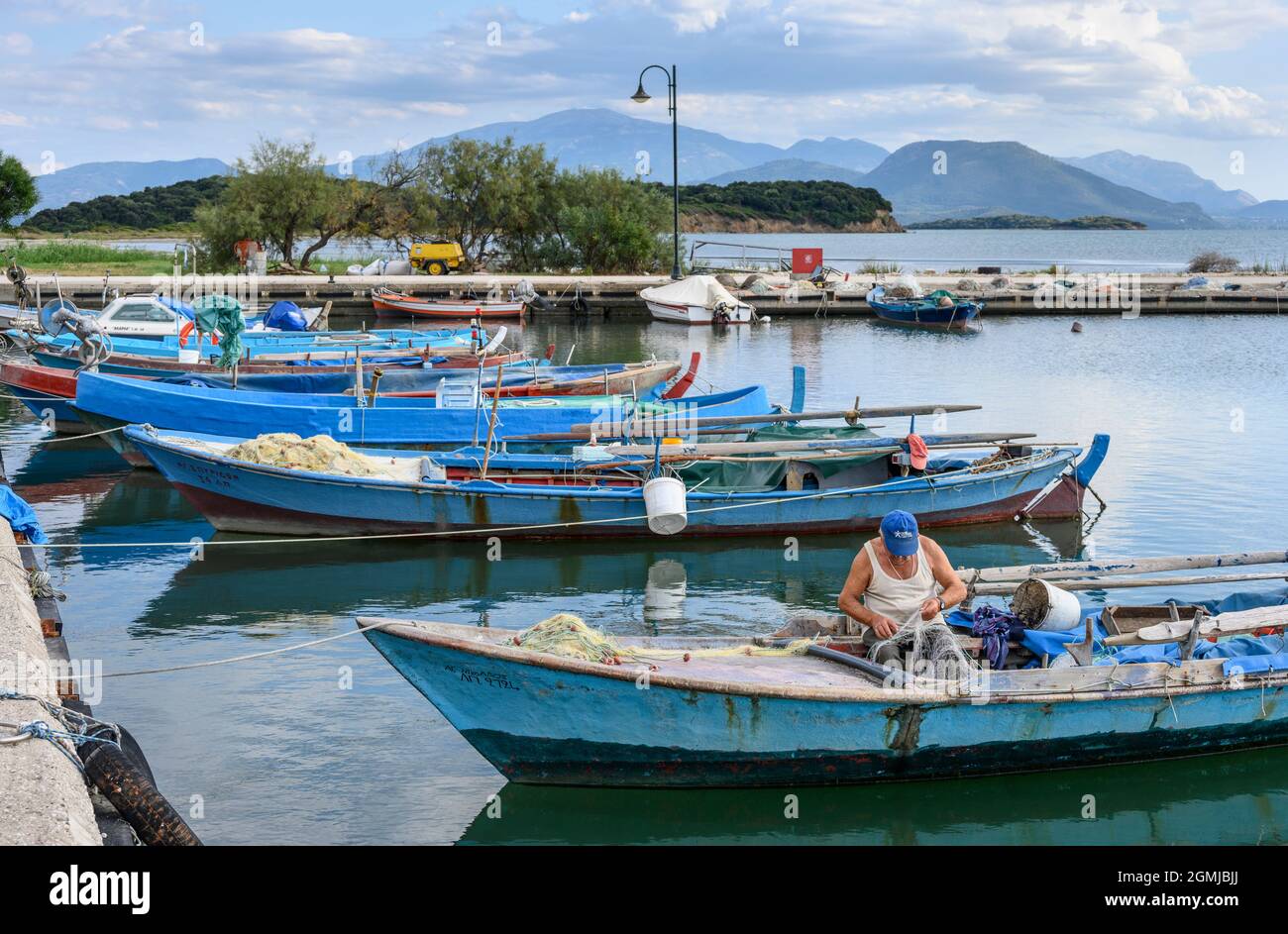Traditional fishing boats in the harbour at the village of Koronisia on Koronisia island in the Ambracian Gulf,  Arta Municipality, Epirus, Greece. Stock Photo