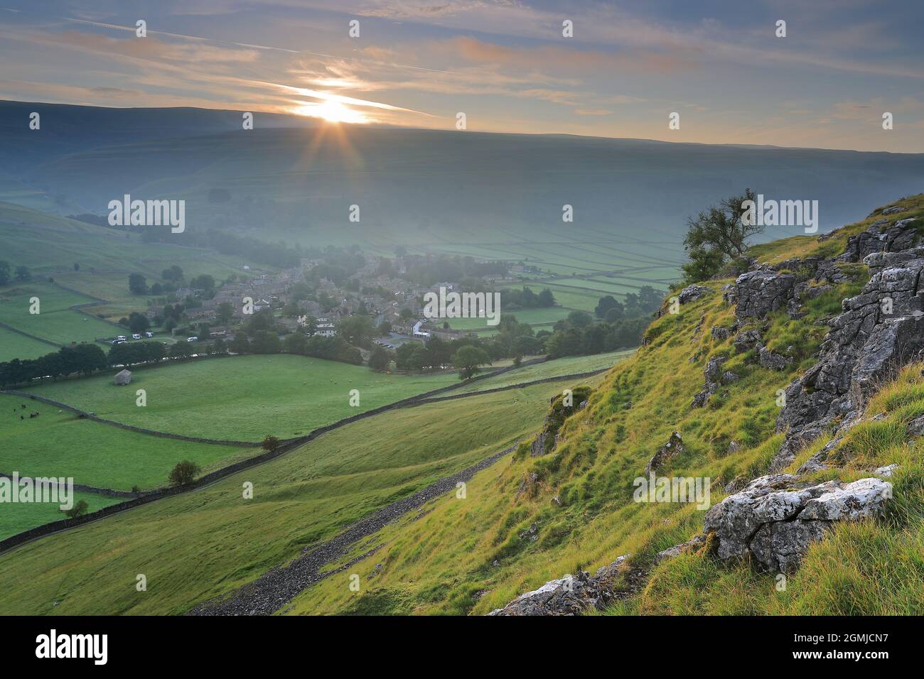 A lone tree clings to the rocky slopes above the village of Kettlewell in Upper-Wharfedale, Yorkshire Dales National Park Stock Photo