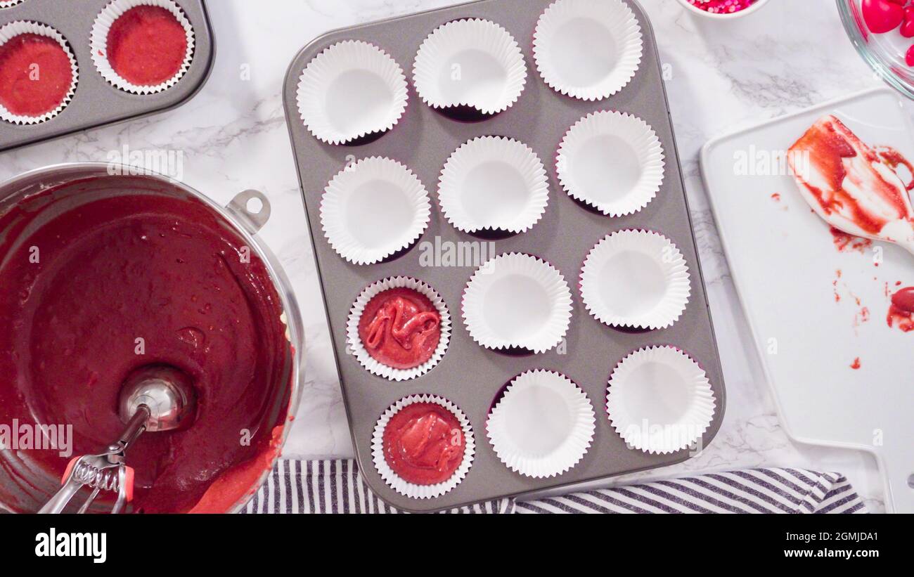 Flat lay. Step by step. Scooping cupcake batter into foil cupcake cups