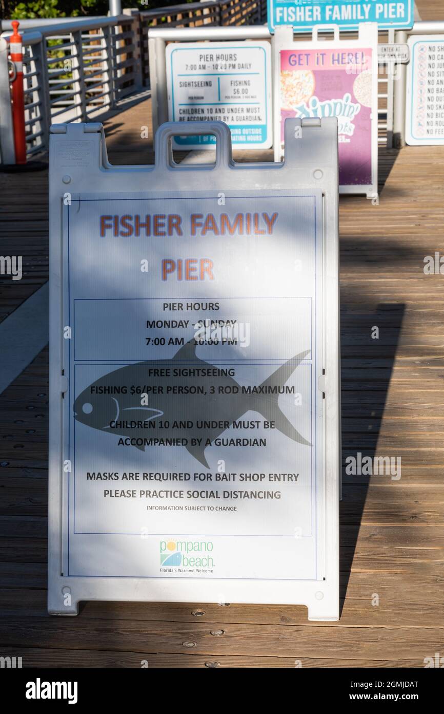 POMPANO BEACH FLORIDA, UNITED STATES - May 30, 2021: A vertical shot of signage on the public pier at Pompano Beach, Florida,  United States Stock Photo
