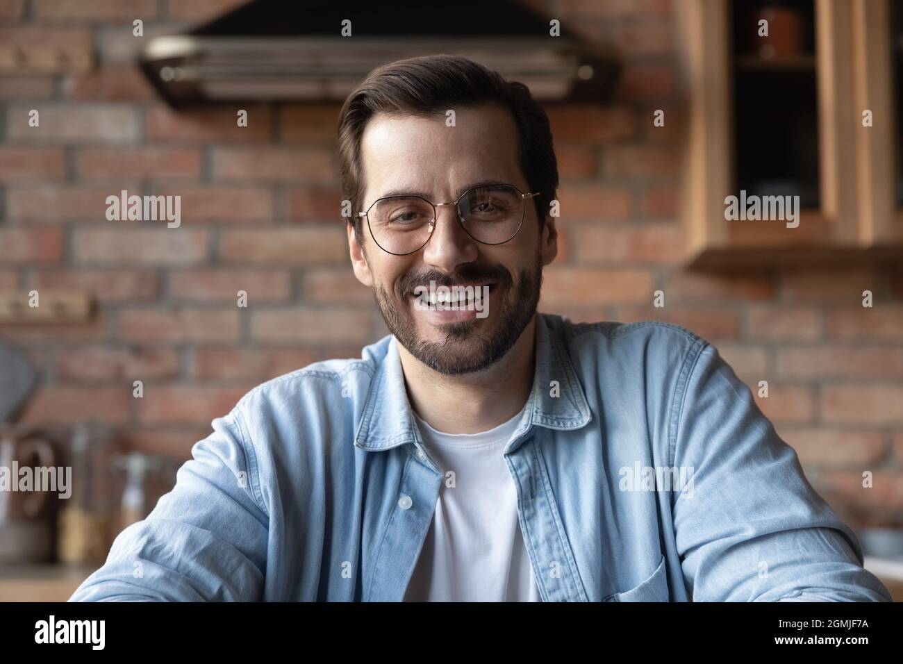 Head shot portrait smiling bearded man in glasses talking Stock Photo