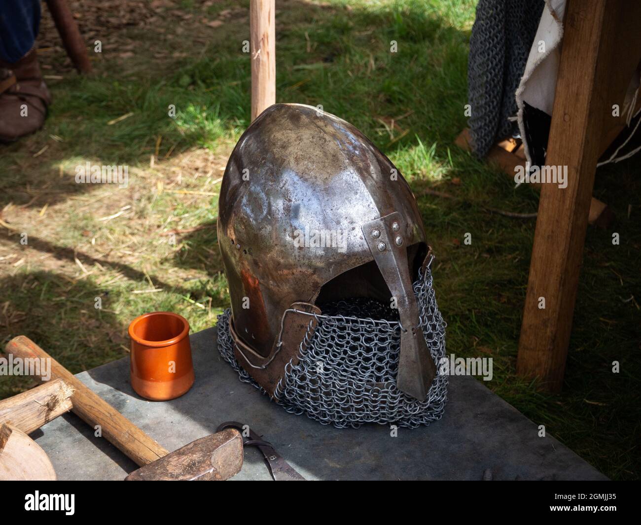 Old medieval armor helmet on the table Stock Photo