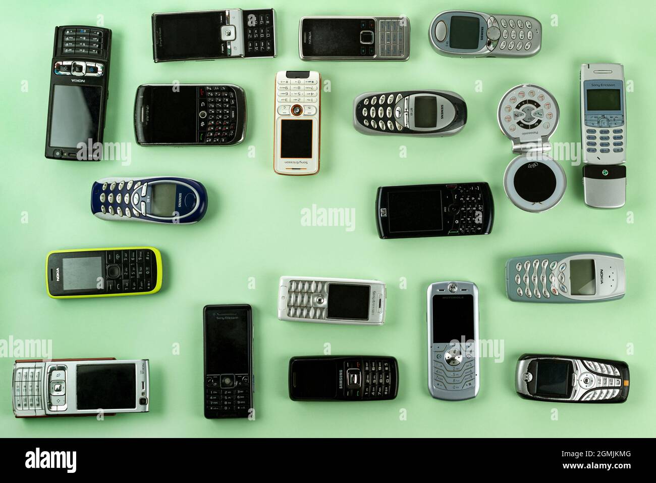 Prague, CZ-  02 November 2020:  A lot of Various brand old mobile phones with media enabled. Many types and generations of  mobile smartphone gadgets. Stock Photo