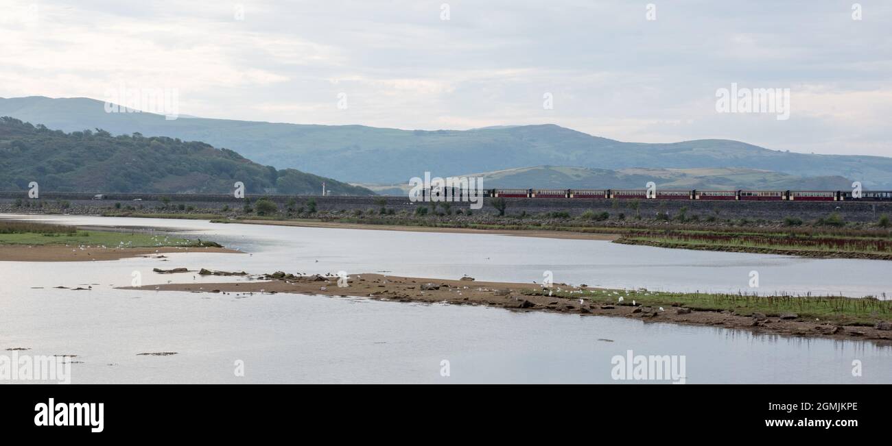 Traeth Glaslyn North Wales Wildlife Trust Nature Reserve with a Welsh Highland train on the Cob, Porthmadog Stock Photo
