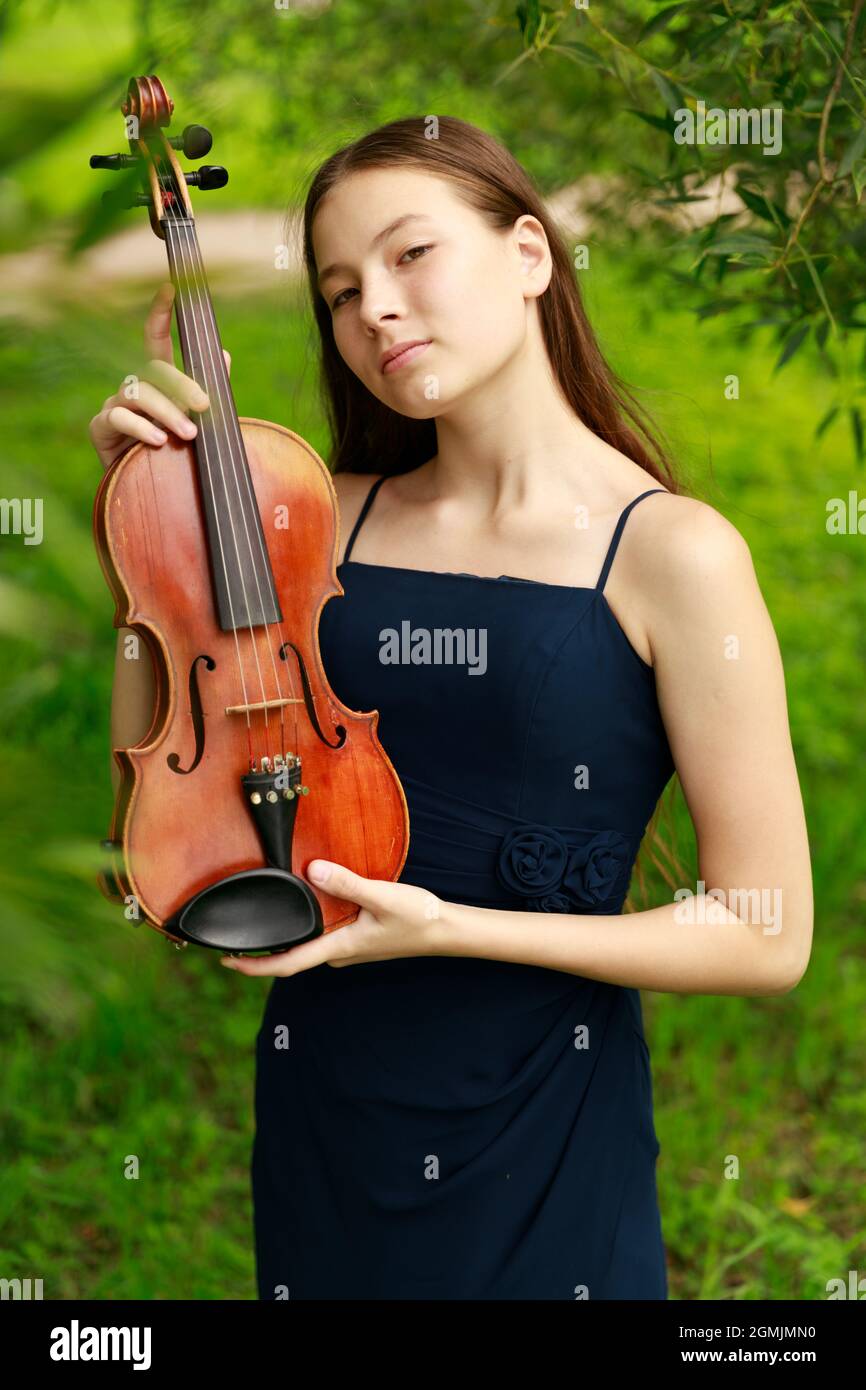Asian girl in nature with violin. High quality photo Stock Photo - Alamy