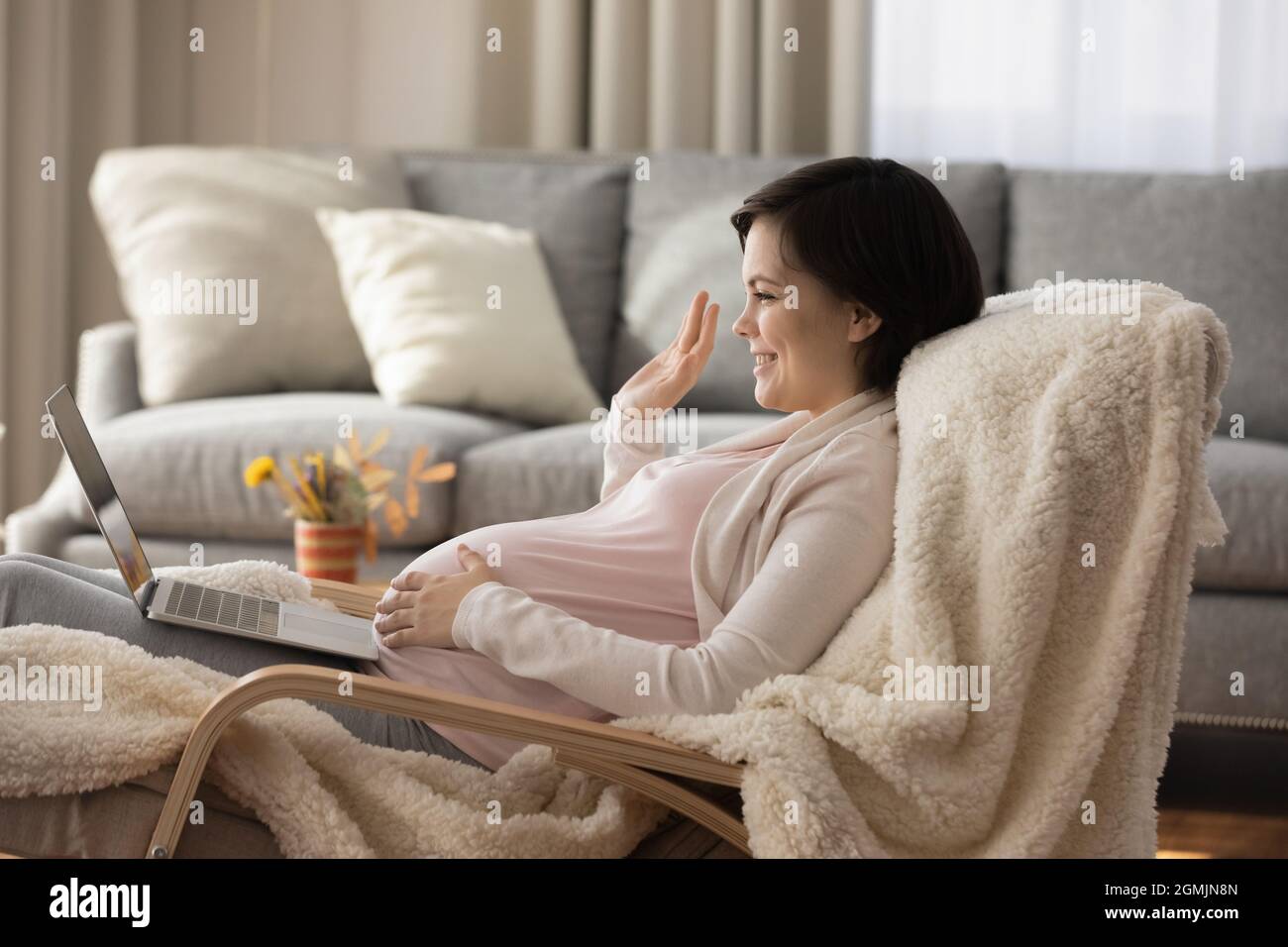 Pregnant woman call husband in videochat say hi using laptop Stock Photo