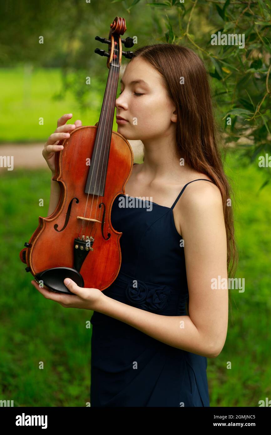 Asian girl in nature with violin. High quality photo Stock Photo - Alamy