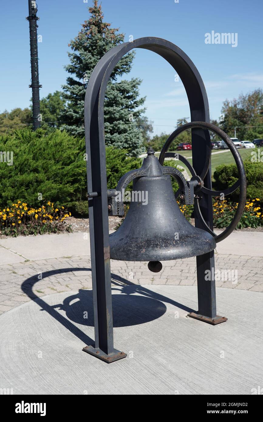 An outdoor black bell sculpture decoration in  Thornbury Canada Stock Photo