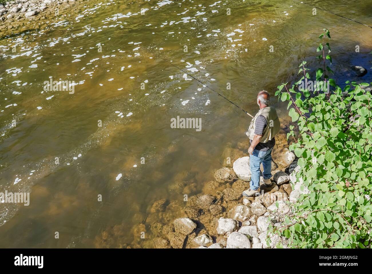 old man fishing by the river Stock Photo