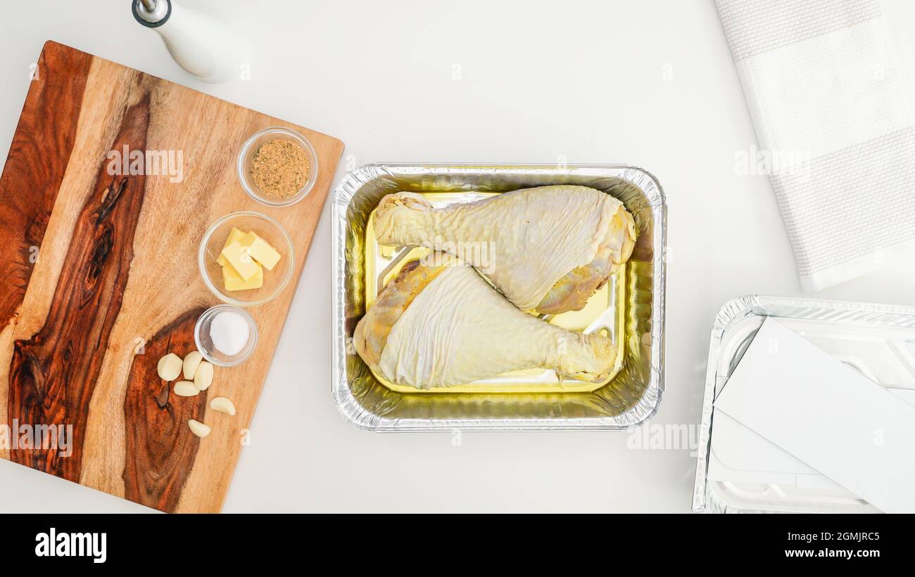 Marinated turkey legs in a disposable bake-ware pan close up on