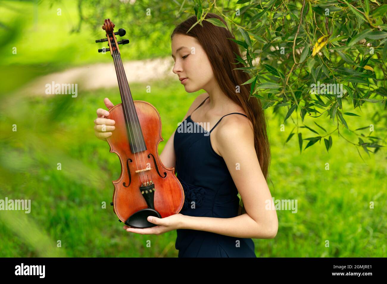 Asian girl in nature with violin. High quality photo Stock Photo - Alamy
