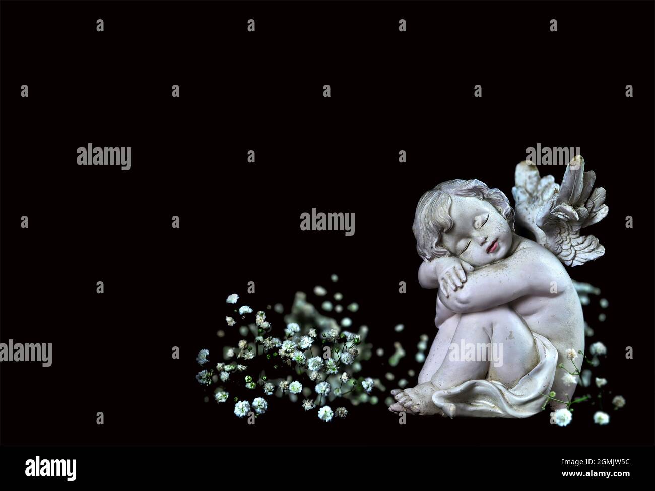 Condolence card with sleeping angel and white flowers isolated on black background Stock Photo
