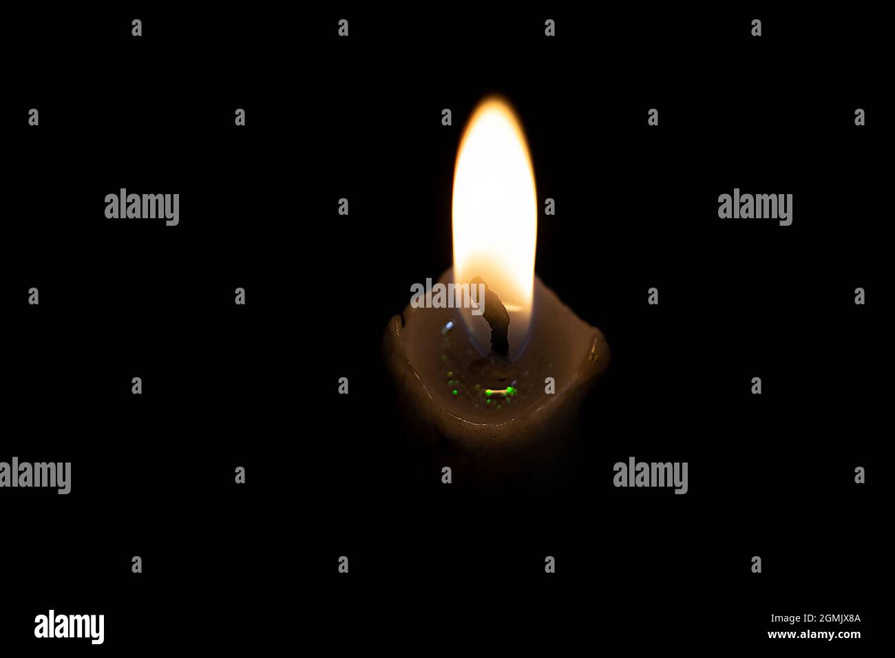 Candle flame in the dark. Fire against a dark background, symbolism of