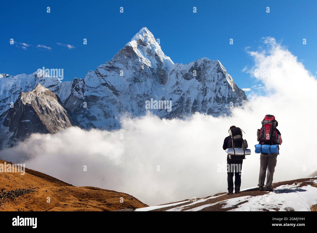Panoramic view of Mount Ama Dablam with two tourists on the way to Everest base camp, Sagarmatha national park, Khumbu valley, Solukhumbu, Nepal Himal Stock Photo