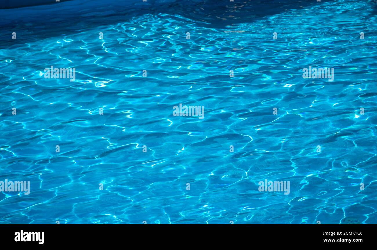 sun reflecting on the water in a pool with gentle ripples Stock Photo