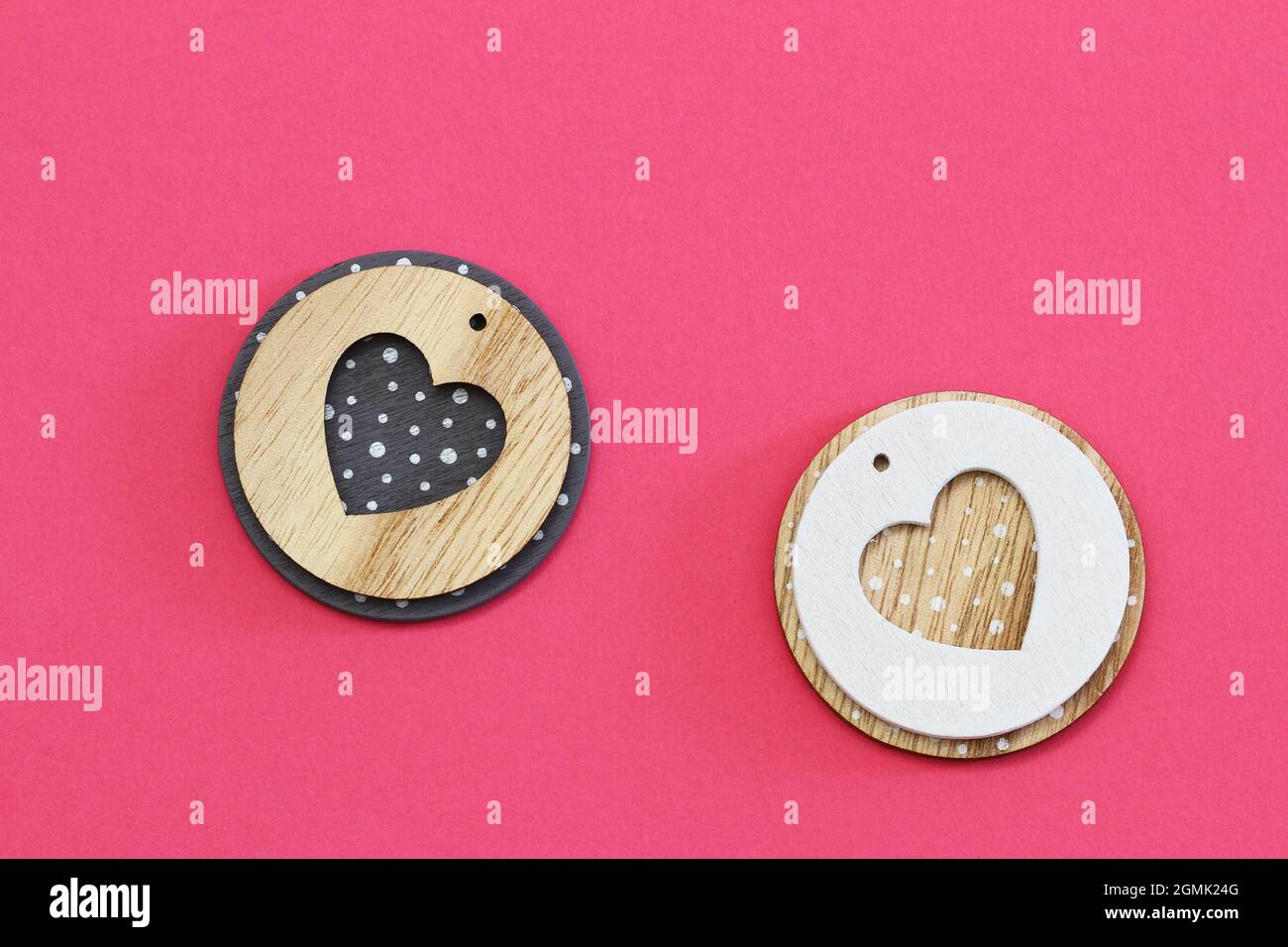 Two wooden hearts on pink background with copy space Stock Photo - Alamy