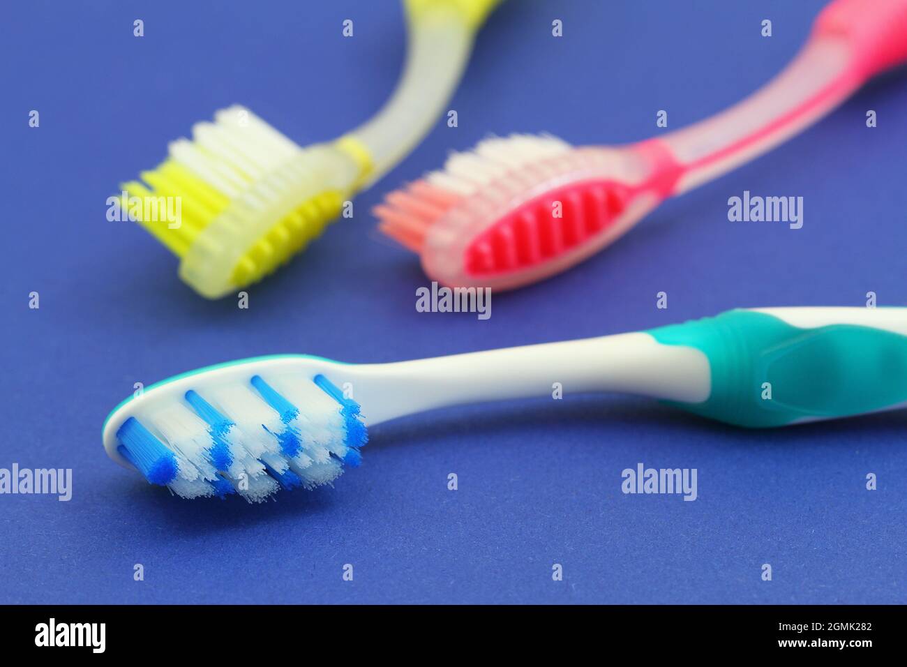 Colorful toothbrushes on blue background, closeup Stock Photo - Alamy