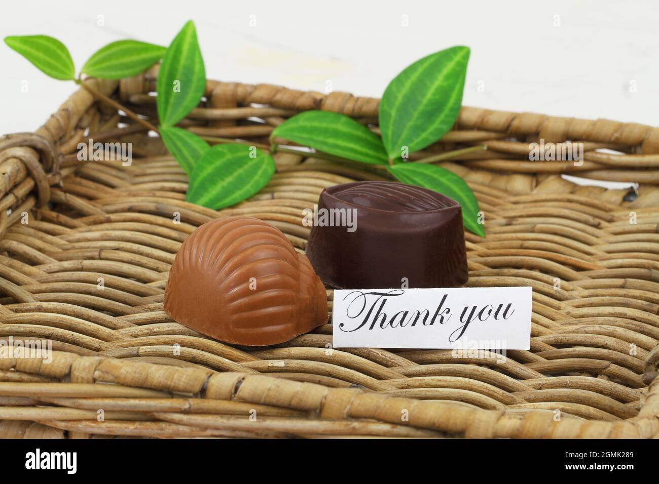 Thank you card with two delicious milk and dark chocolates on wicker tray Stock Photo
