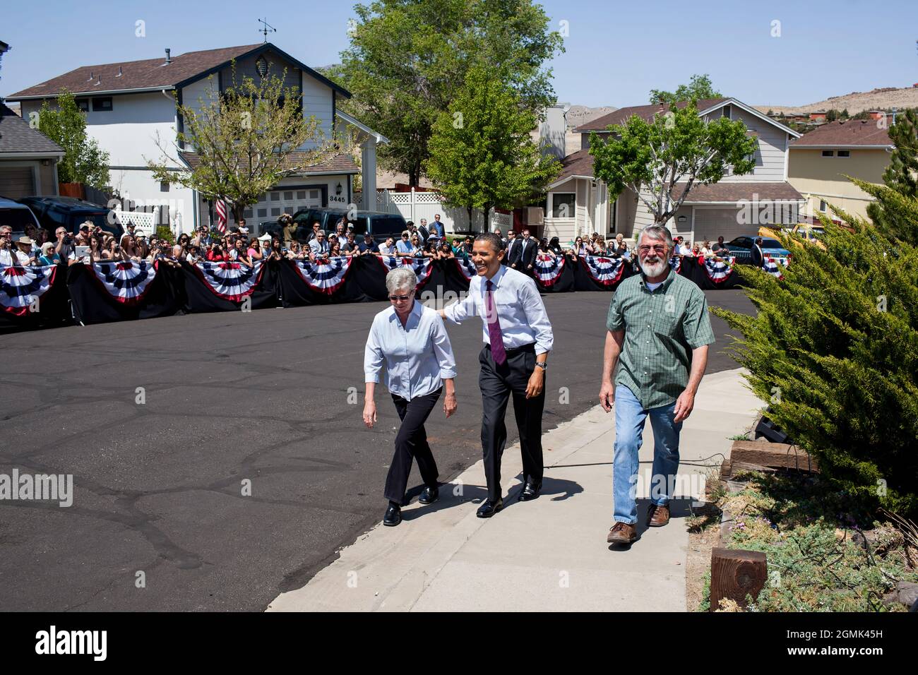 President Barack Obama walks with Valerie and Paul Keller to their home to discuss the economy and mortgage refinancing, in Reno, Nev., May 11, 2012. (Official White House Photo by Pete Souza) This official White House photograph is being made available only for publication by news organizations and/or for personal use printing by the subject(s) of the photograph. The photograph may not be manipulated in any way and may not be used in commercial or political materials, advertisements, emails, products, promotions that in any way suggests approval or endorsement of the President, the First Fami Stock Photo