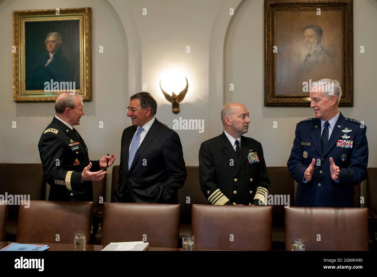 General Martin Dempsey, Chairman of the Joint Chiefs of Staff, left, talks with Defense Secretary Leon Panetta as Admiral James G. Stavridis talks with General Douglas M. Fraser, right,  before a meeting of Combatant Commanders and senior military leadership in the Cabinet Room of the White House, May 15, 2012. (Official White House Photo by Pete Souza) This official White House photograph is being made available only for publication by news organizations and/or for personal use printing by the subject(s) of the photograph. The photograph may not be manipulated in any way and may not be used i Stock Photo