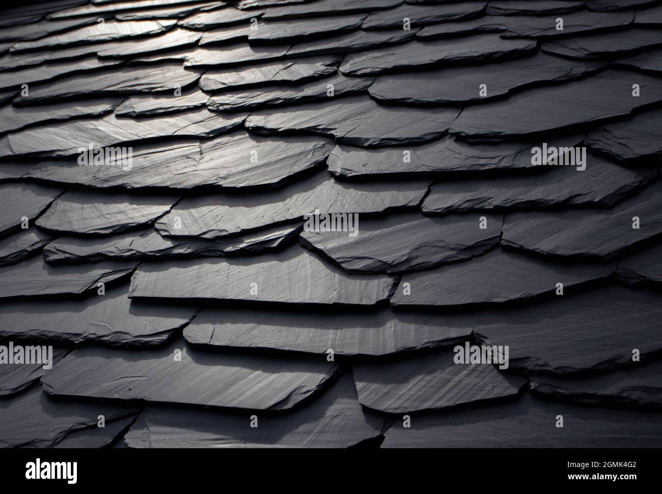 Dark gray abstract scaly background. Black natural slate roof. Stock Photo