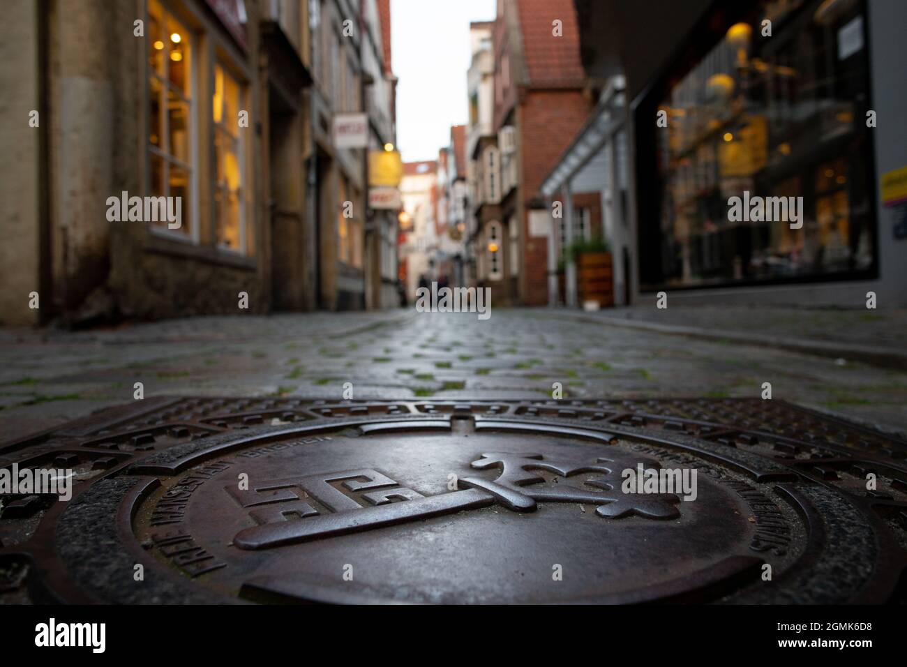 Low perspective shot of an ancient pedestrian road in the famous historic district Schnoor in Bremen, Germany in the evening Stock Photo