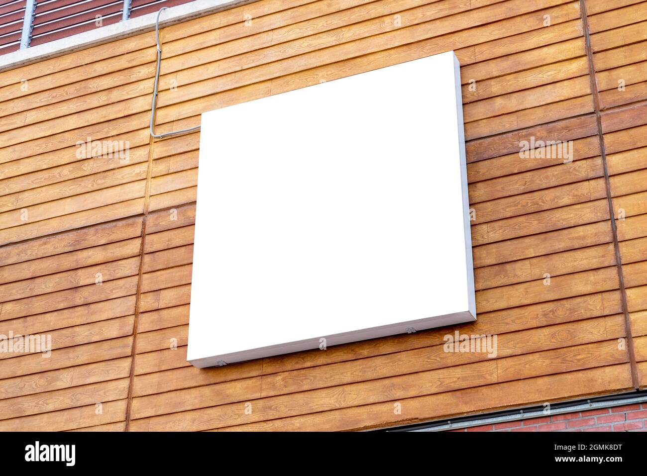 Square billboard mockup on wooden building wall Stock Photo