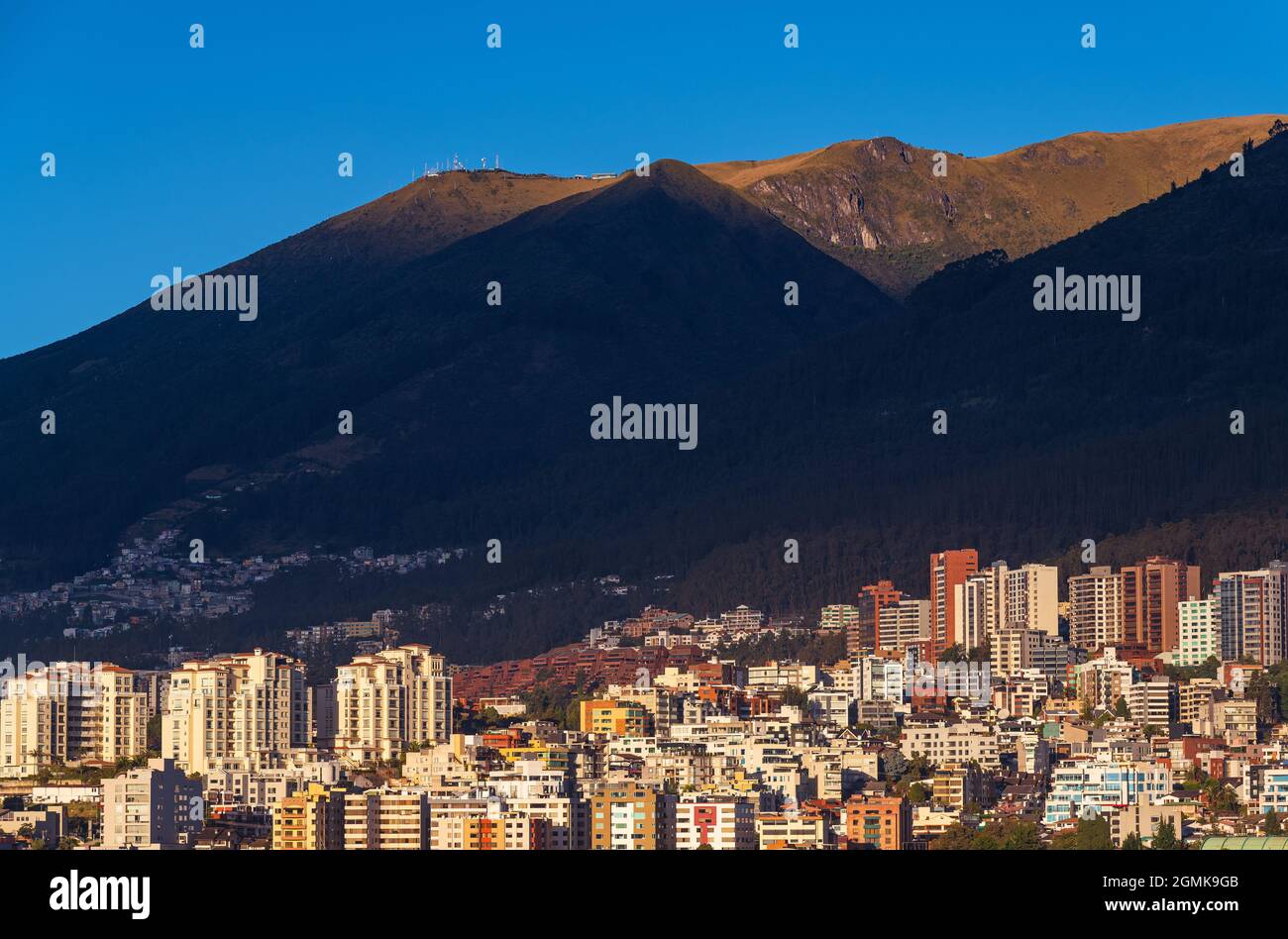Quito city skyline at sunrise with modern high rise apartment building with Pichincha volcano