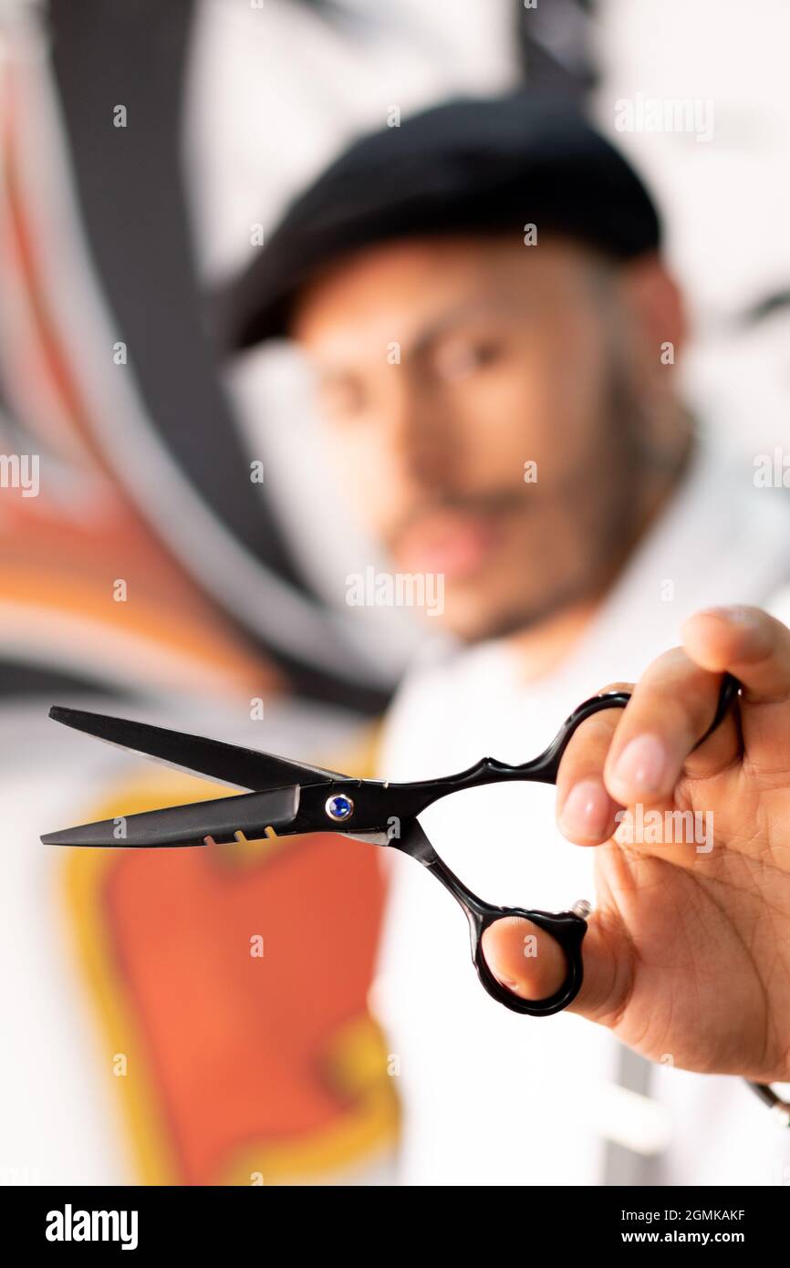 Barber showing his scissors, his working tool. barber shop. Stock Photo