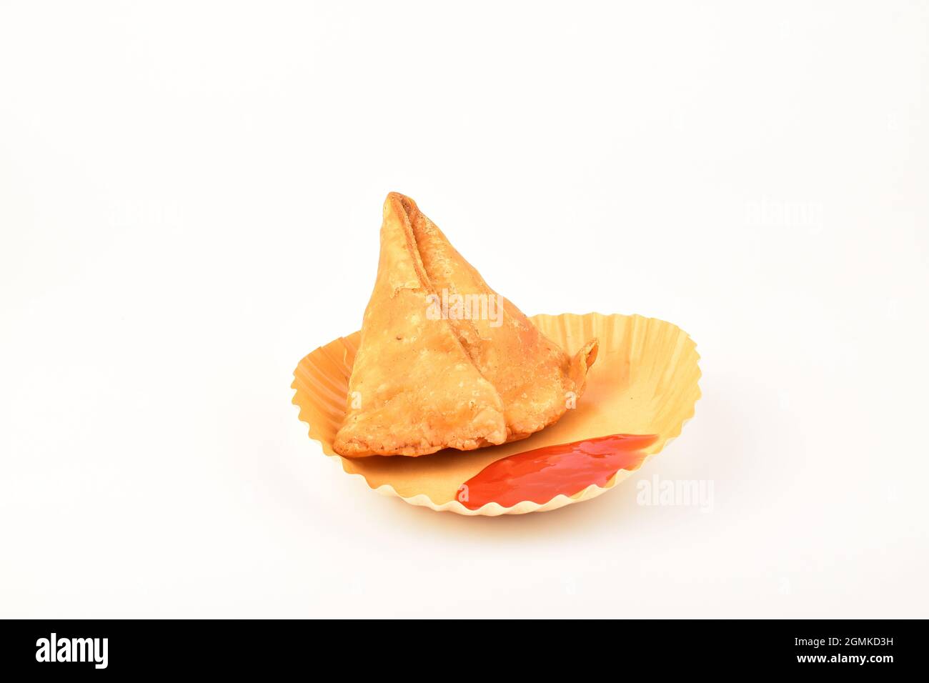 samosa and tomato ketchup in disposal plate over white background Stock Photo