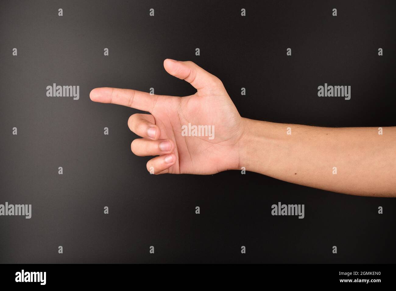 hand point out on black background, hand giving direction sign Stock Photo