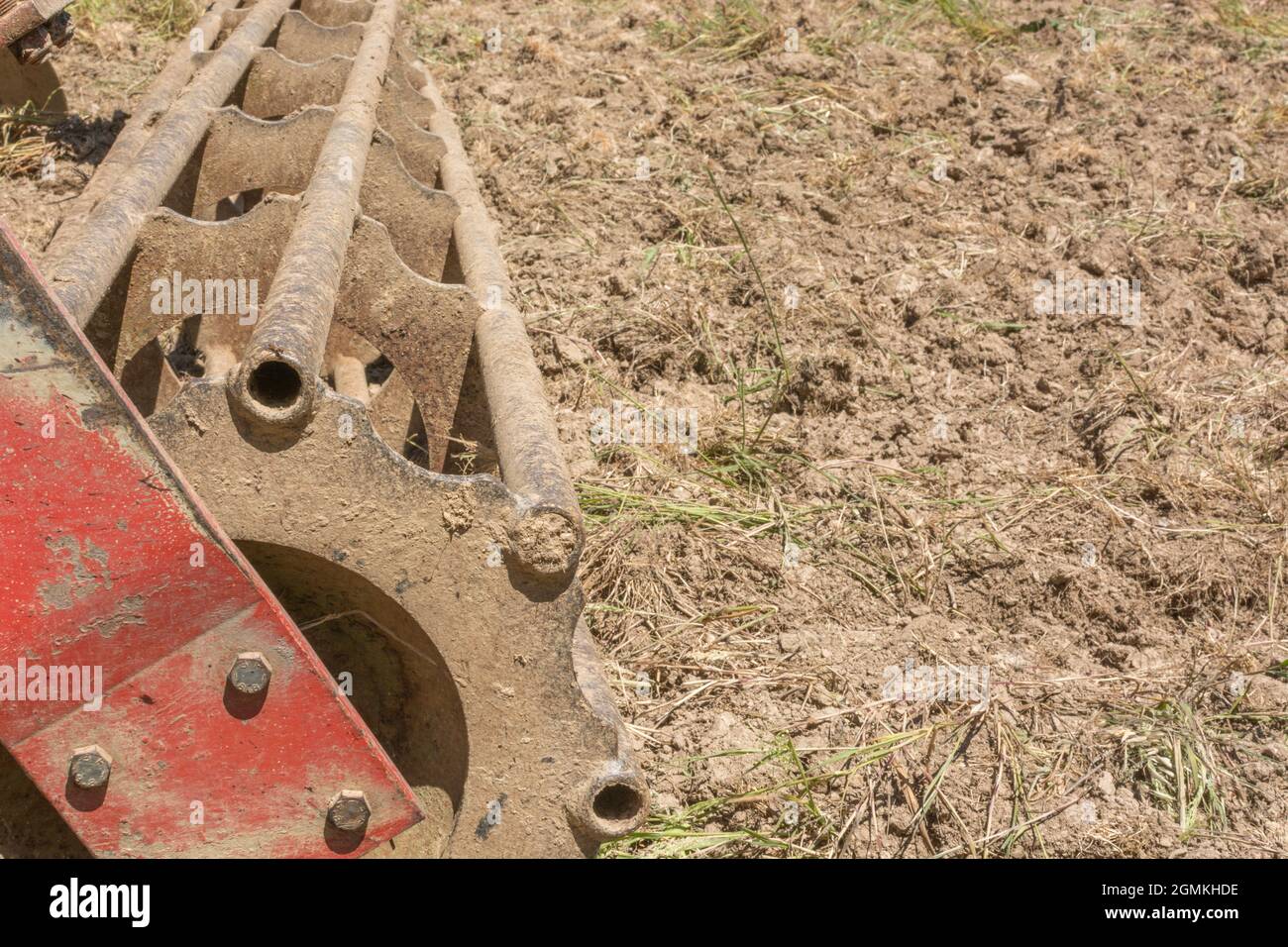 Disc cultivator or disc harrow farm equipment - not quite sure how to describe since has discs and clod breaker rollers. For UK farming & agriculture Stock Photo