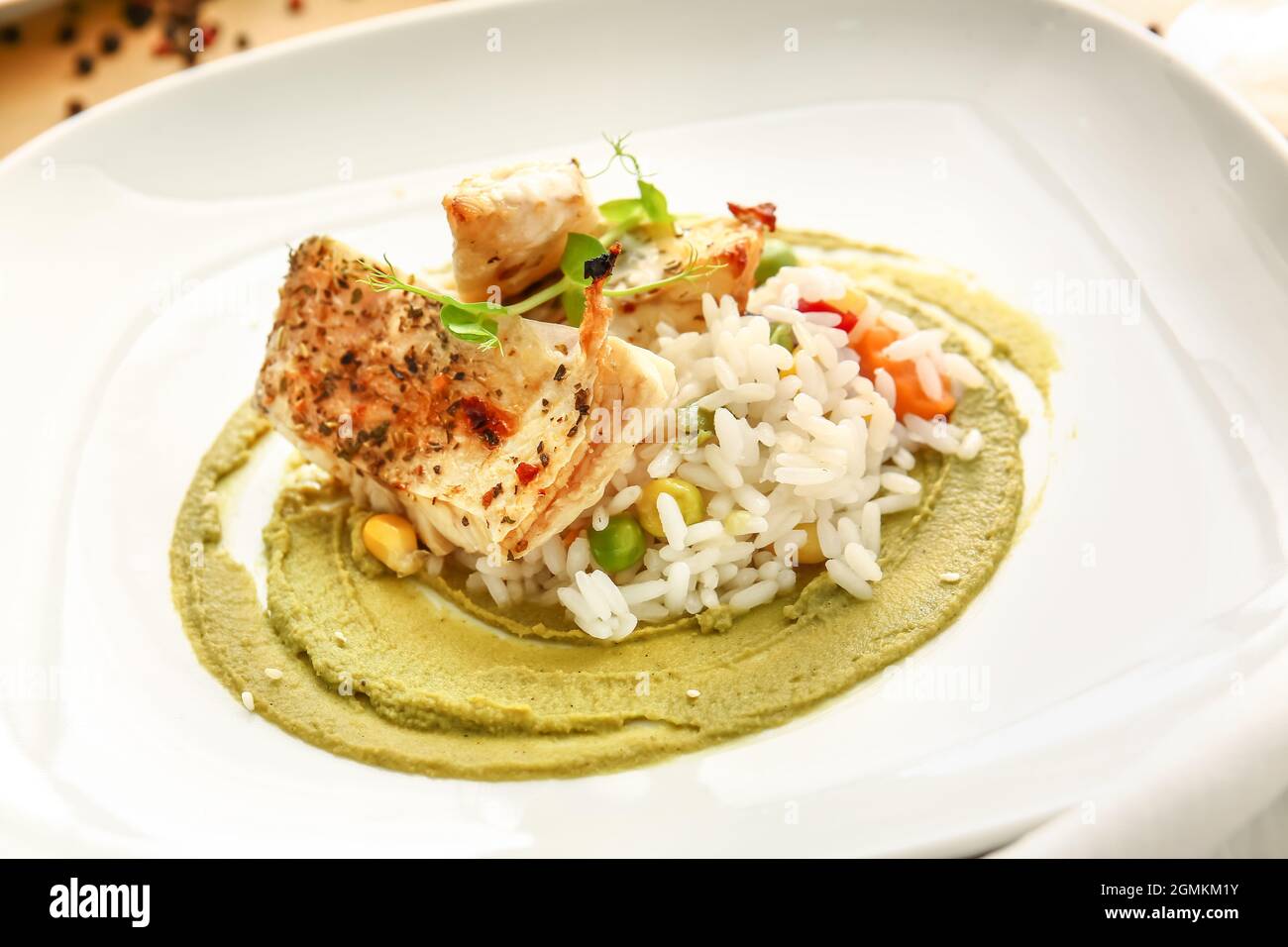 Plate with healthy baked cod fillet, rice and guacamole sauce on color ...