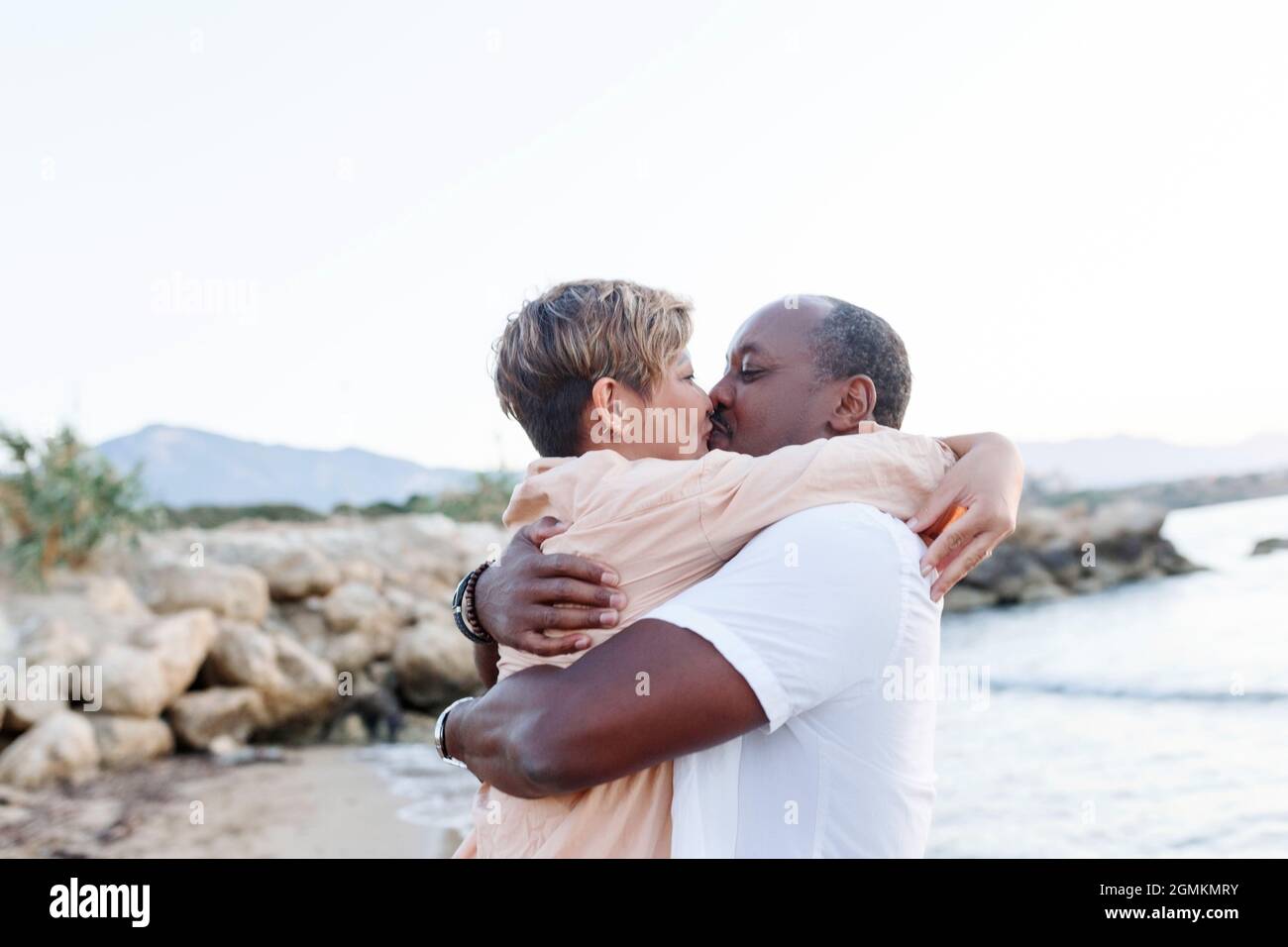 Multiracial couple kissing at the beach.Love lifestyle concept . Stock Photo