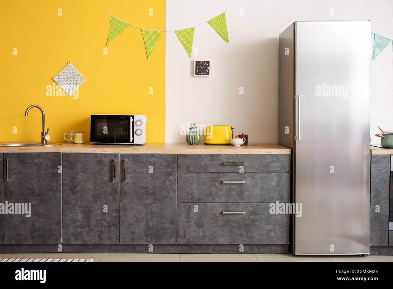 Interior of kitchen with modern microwave oven and refrigerator Stock