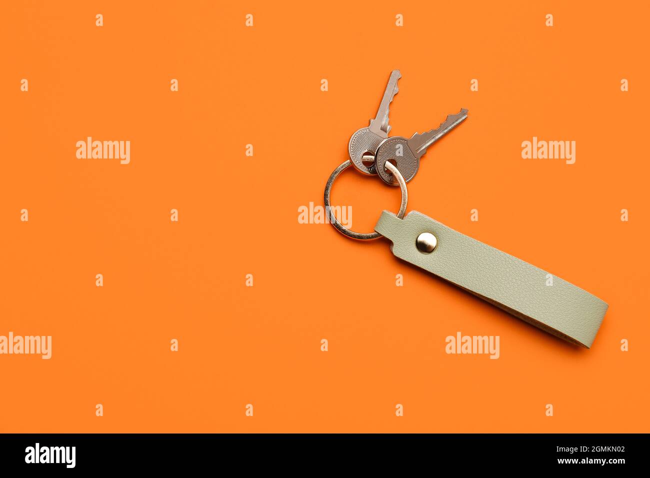 Keys with leather keychain on color background Stock Photo
