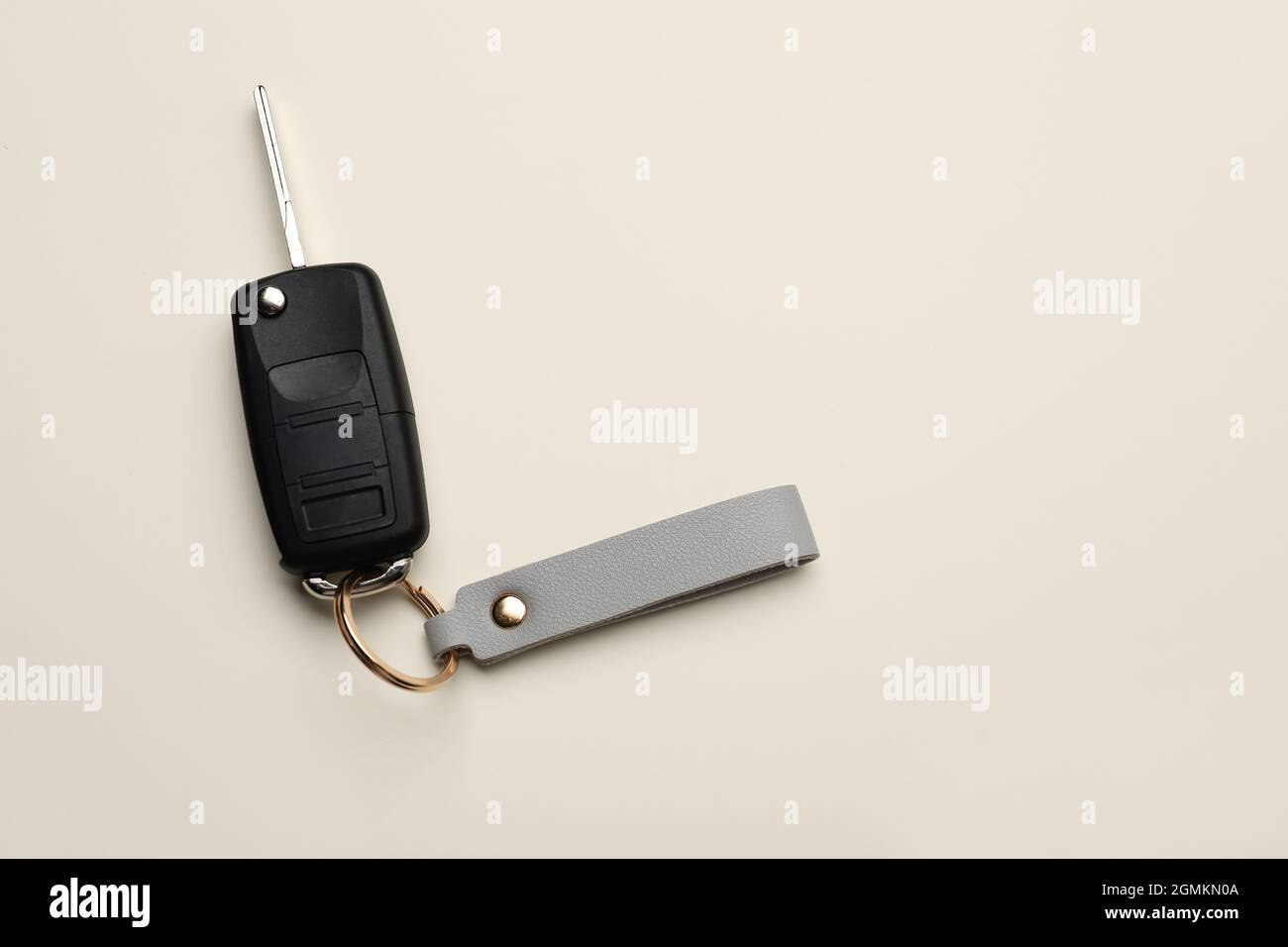 Car key with leather keychain on light background Stock Photo