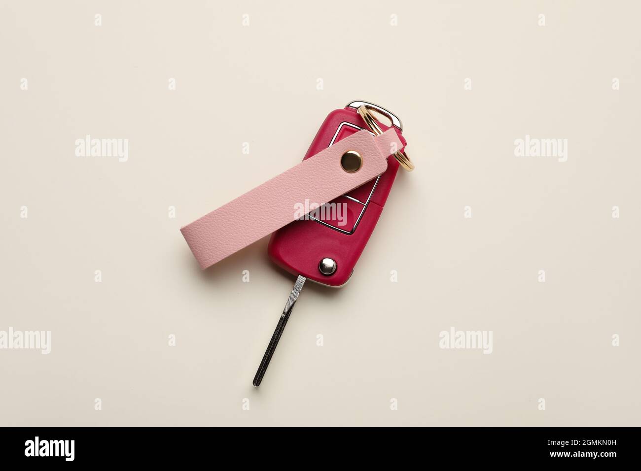 Car key with leather keychain on light background Stock Photo