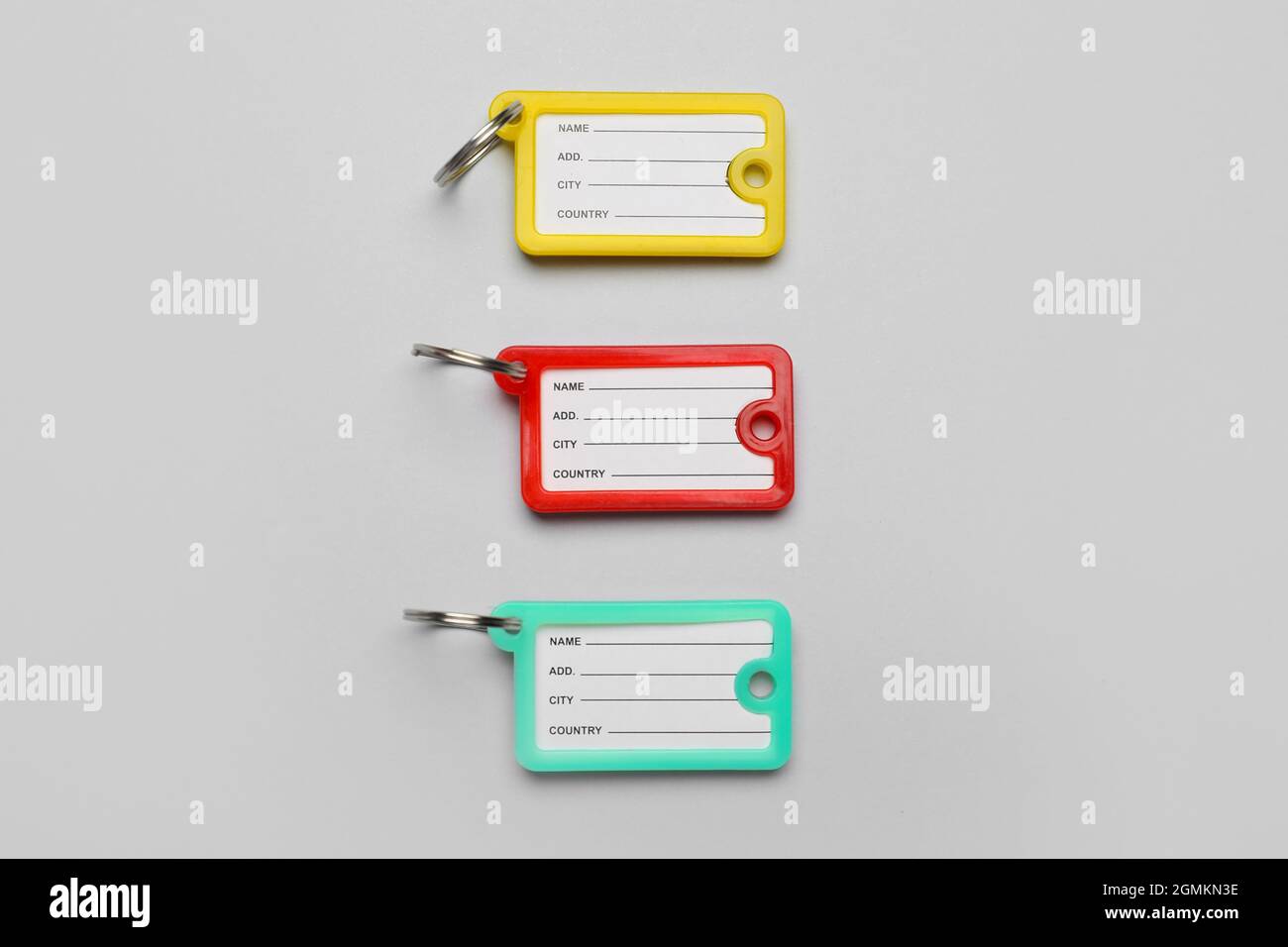 Plastic key tags on grey background Stock Photo