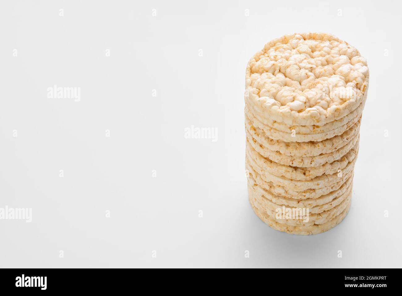 Stack of puffed rice crackers on white background Stock Photo Alamy