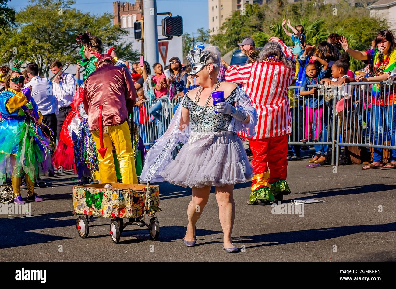 Mardi Gras revelers parade in the streets during the Joe Cain Day Mardi Gras parade, Feb. 26