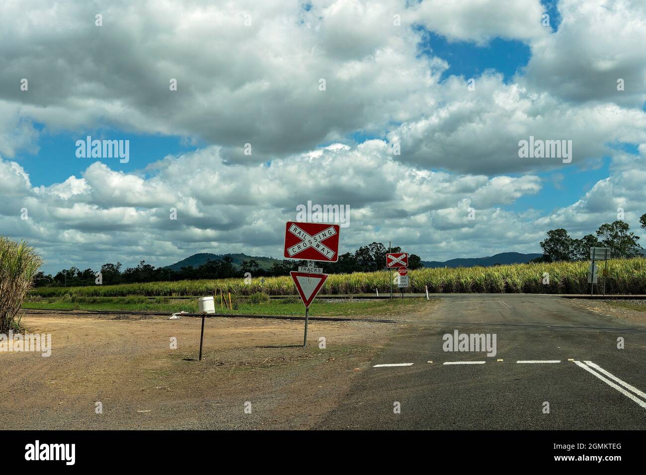 Look Out For Train Sign A railway crossing with stop signs and warnings to look out for trains ...