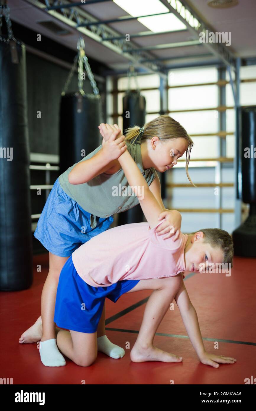 Boy and girl in pair exercising self-defense movements Stock Photo - Alamy