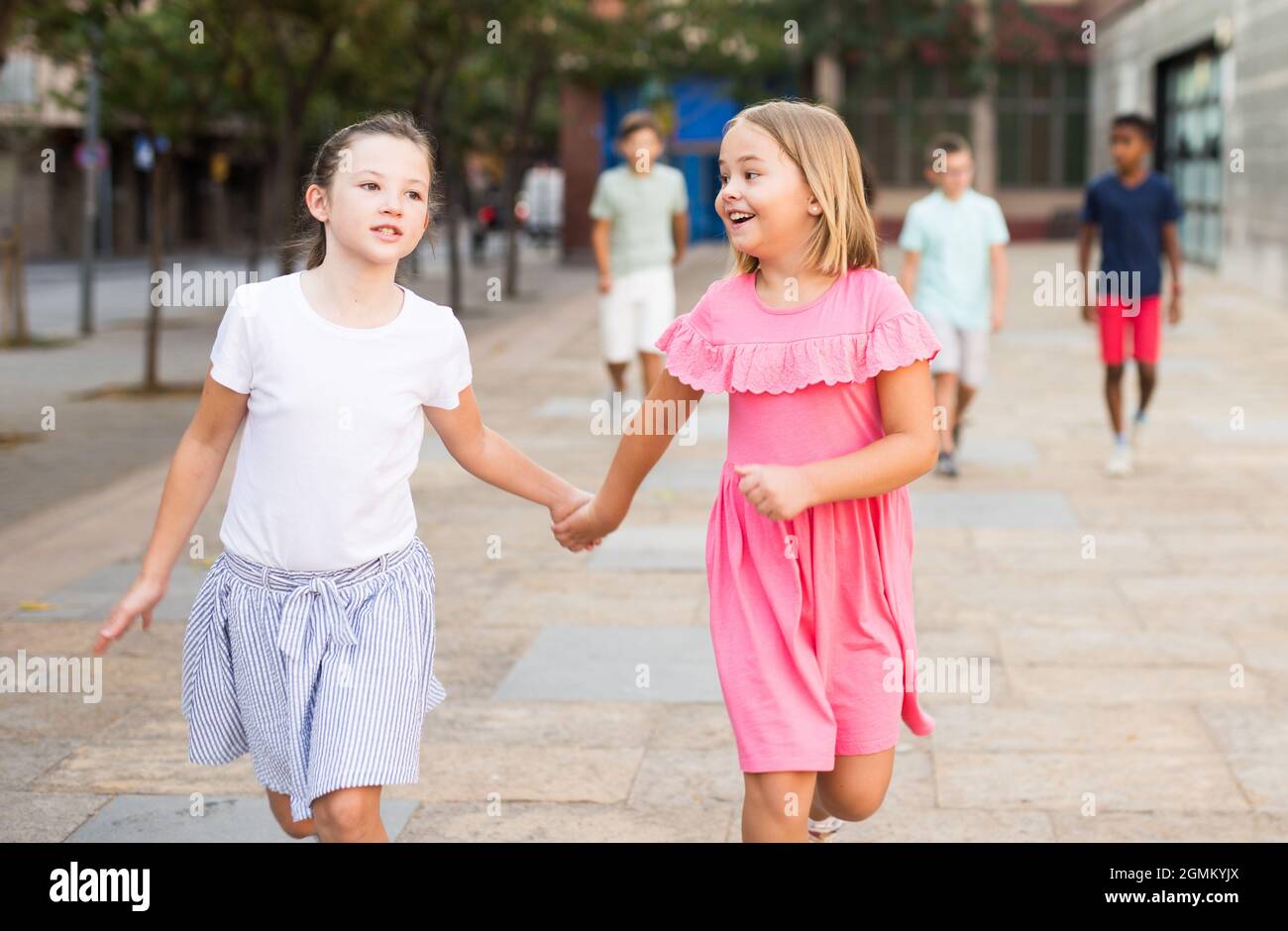 Two girls walking together outdoors Stock Photo - Alamy