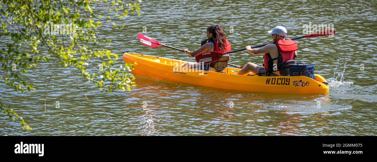 Couple kayaking on the Chattahoochee River just north of Atlanta, Georgia, in a tandem rental kayak from Nantahala Outdoor Center (NOC). (USA) Stock Photo