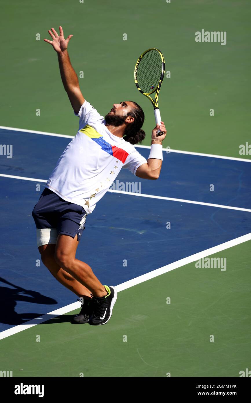 New York City, United States. 19th Sep, 2021. Venezuela's Dimitri Badra  serving to South Africa's Ruan Roelofse in Davis Cup action today in the  World Group II first round match between the