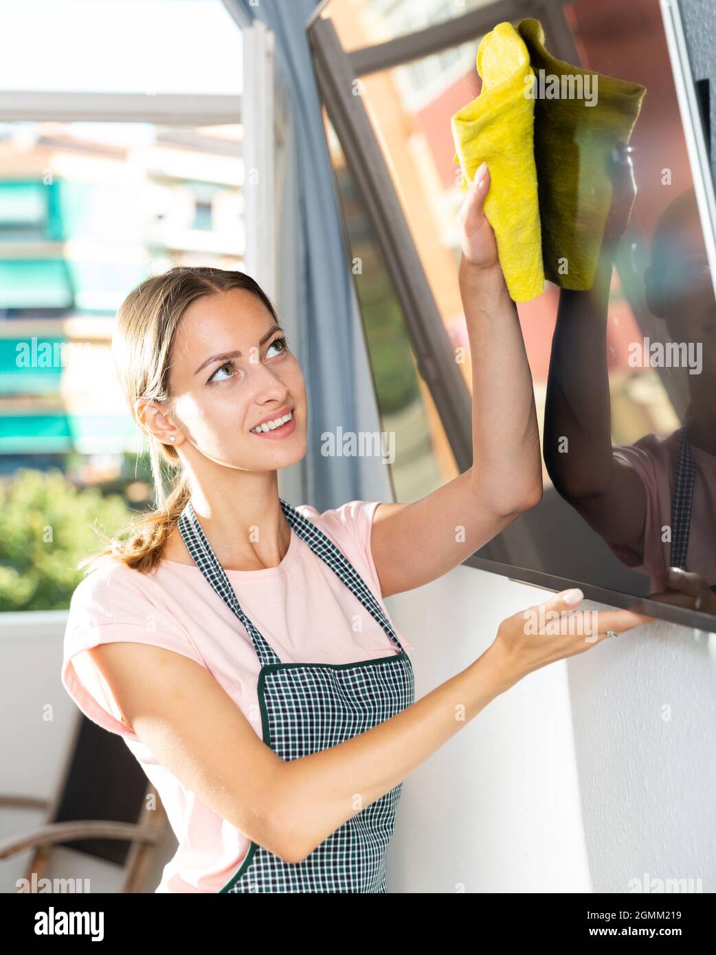 Female cleaning TV screen Stock Photo Alamy