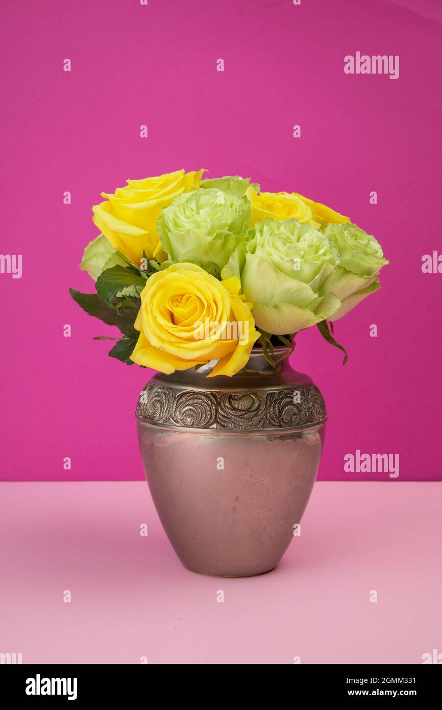 flower arrangement with roses inside a metal vase, decoration with